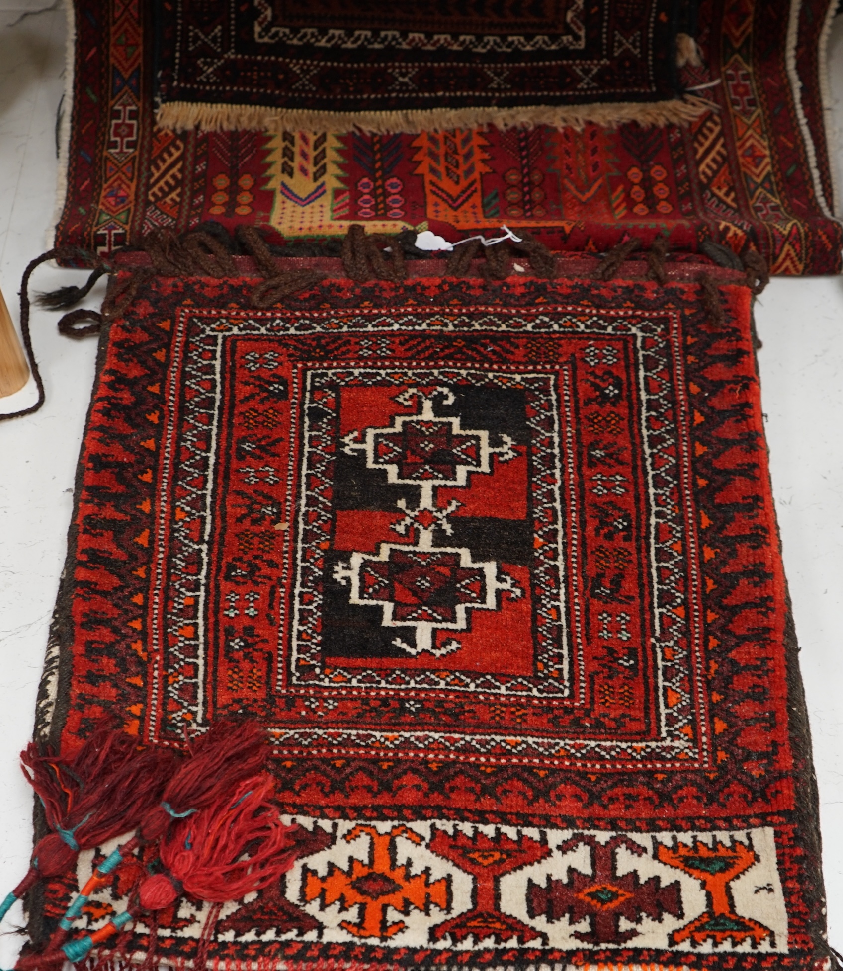 A saddle bag and two prayer rugs. Condition - fair